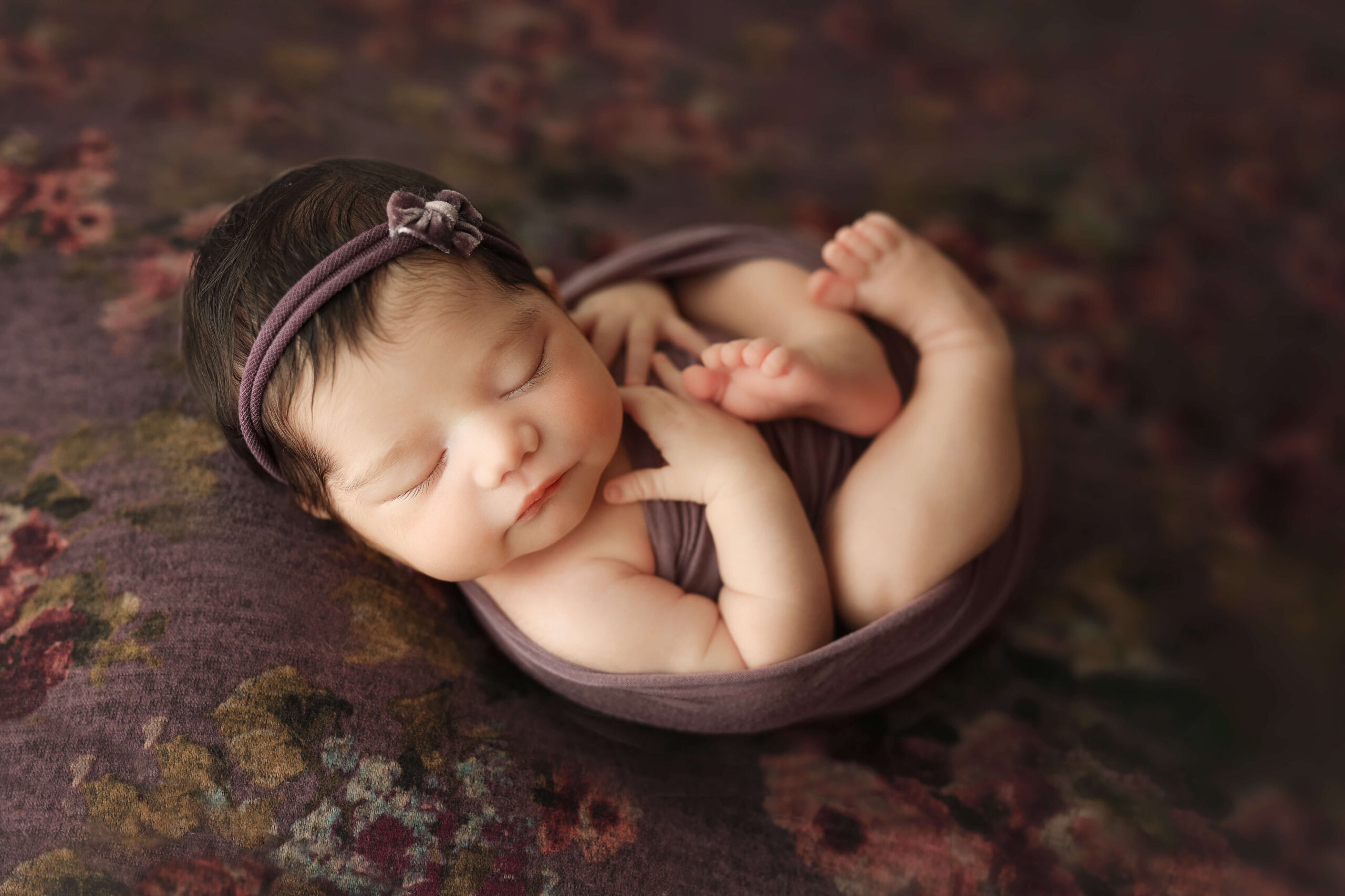 newborn baby safely posed by an experienced Northern Virginia professional newborn photographer