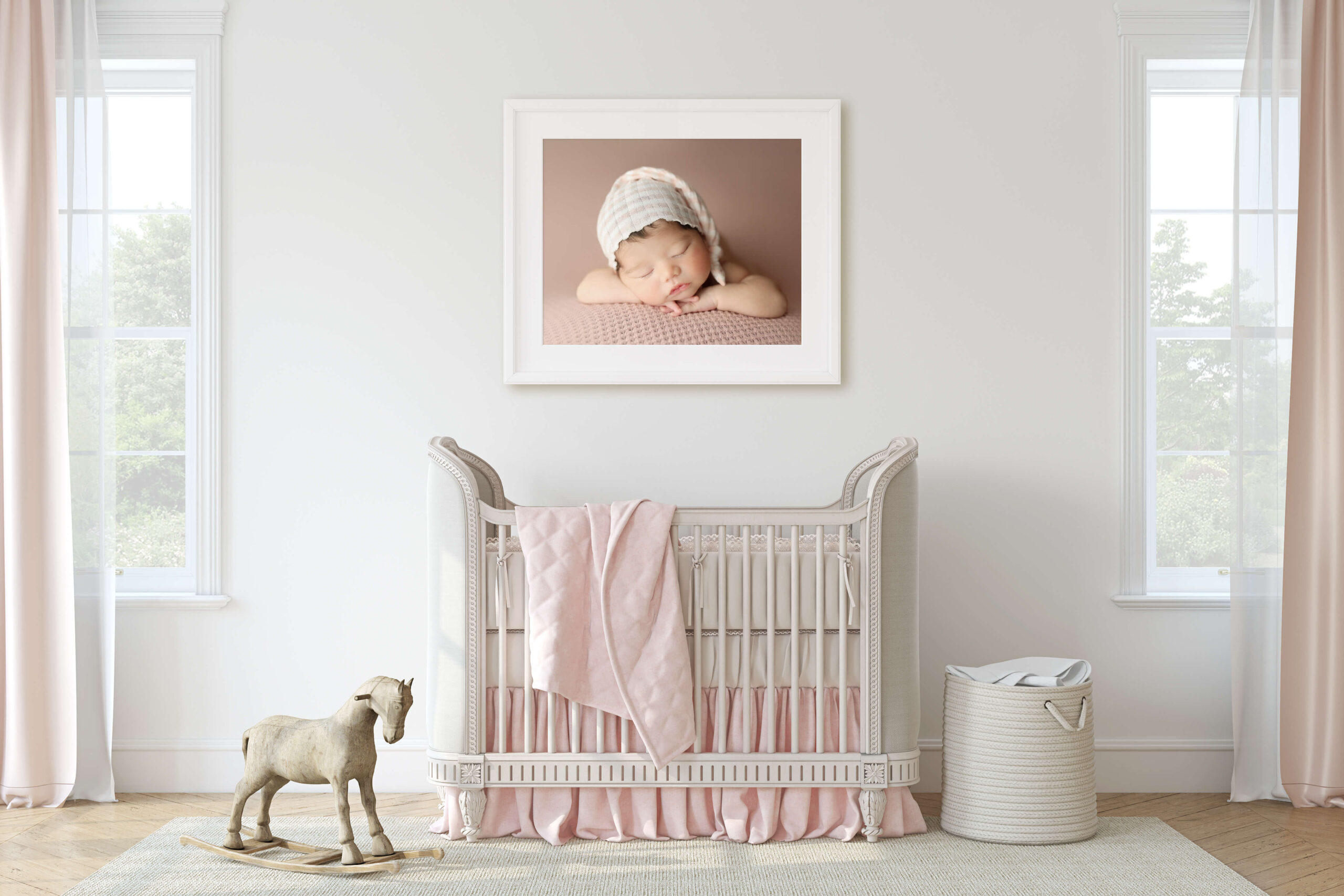 newborn girls nursery with a framed and printed newborn photo on the wall from Newborn Photography Studios that offer Printed Products