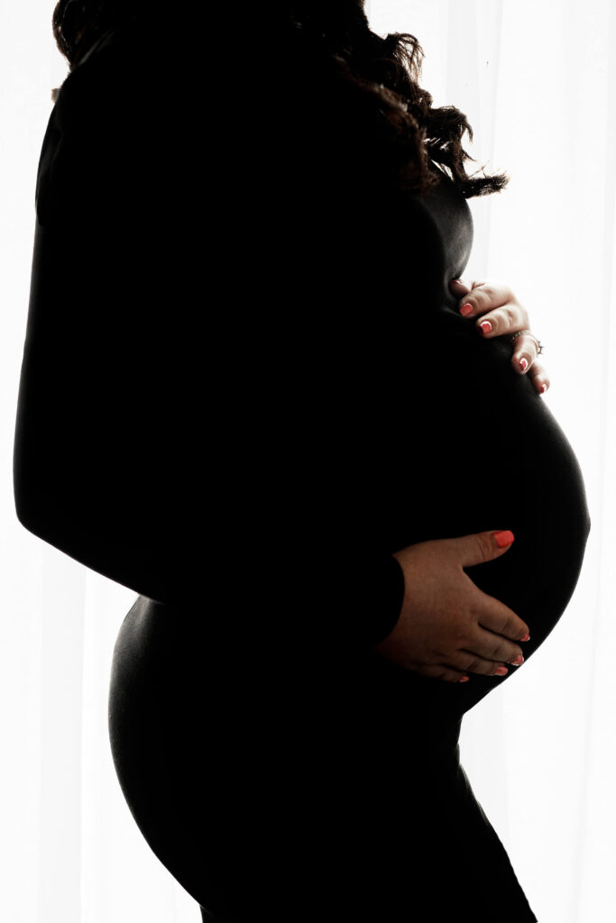 pregnant mother in a black gown studio creative Maternity photoshoot reston va