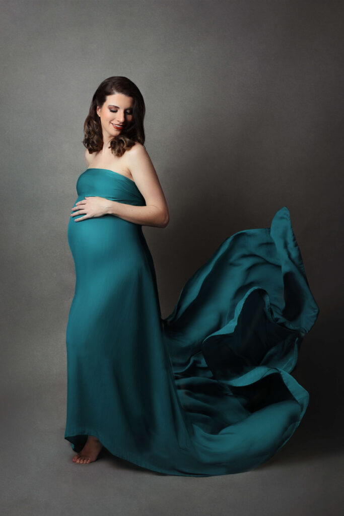 pregnant mother wearing a flowey fabric maternity dress in her maternity session in va by Maternity Photographer Tysons Corner VA