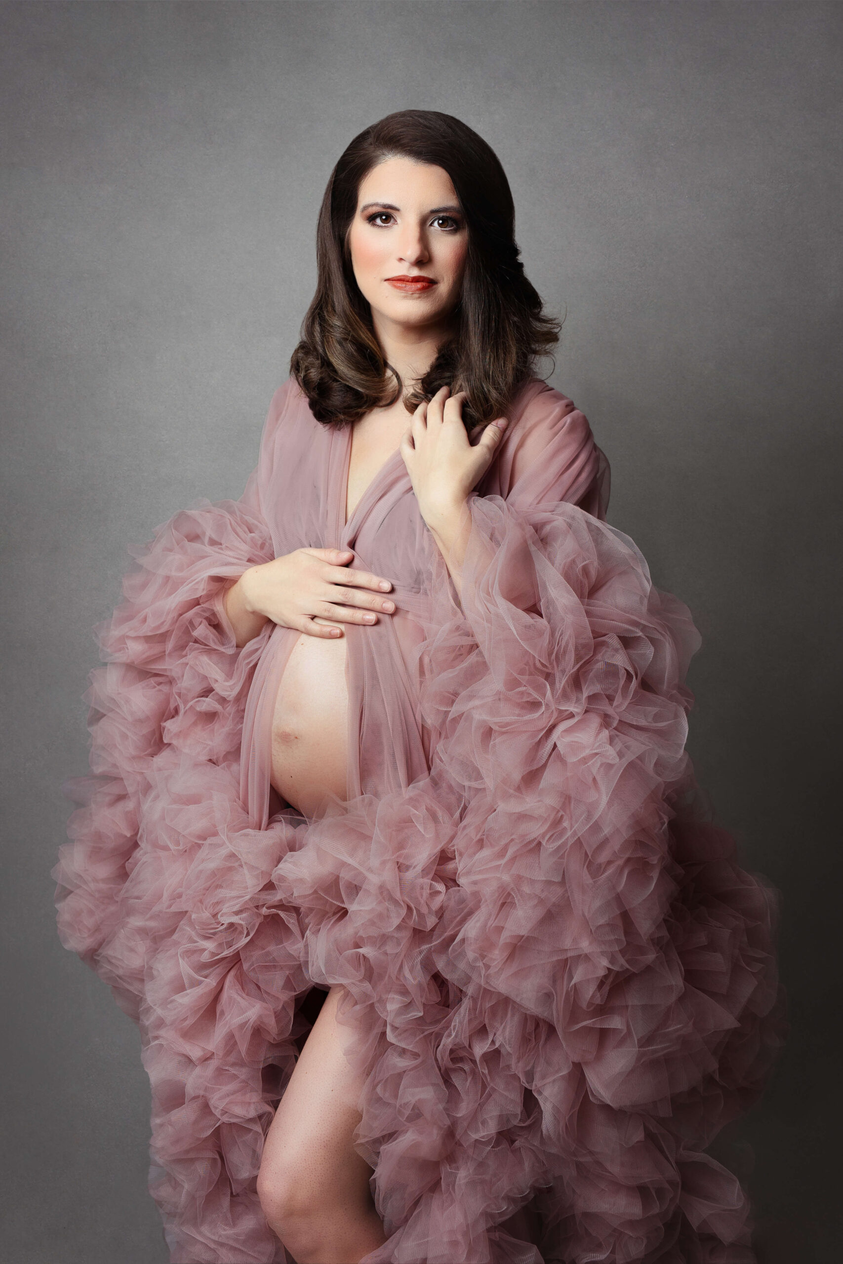 pregnant woman wearing tulle fluffy pink maternity robe at her northern va maternity session