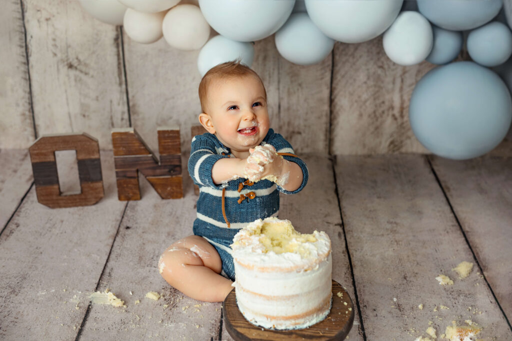 baby playing with a cake at a Leesburg VA Cake Smash Photoshoot