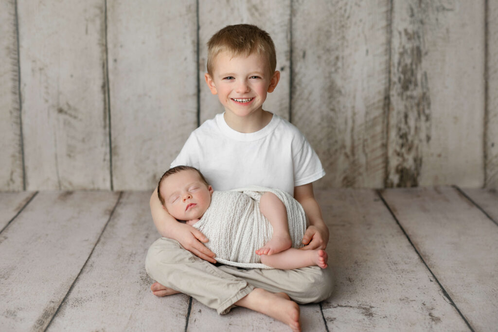 newborn being held by his big brother taken by a Northern Virginia Newborn Photographer
