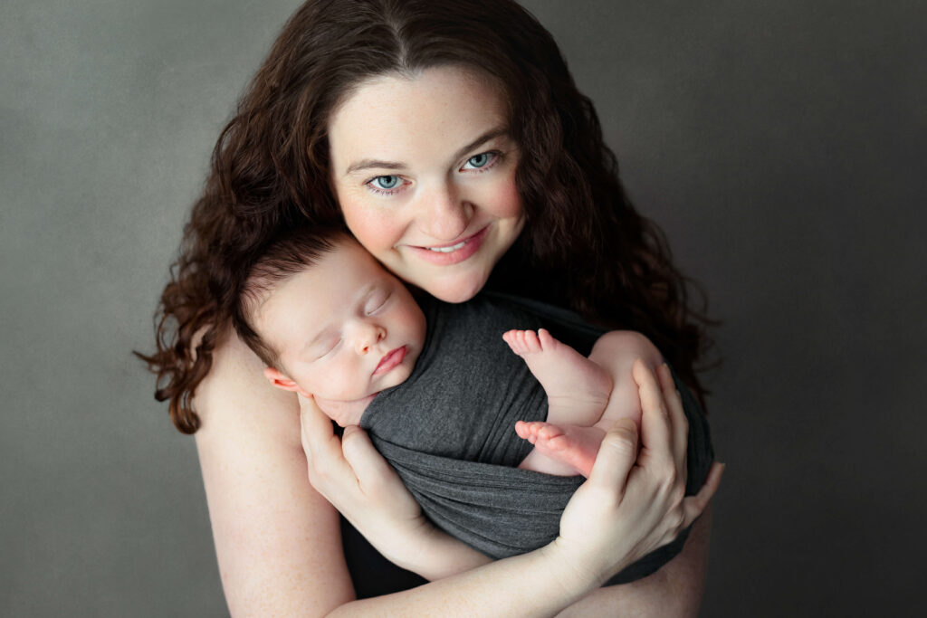 mom holding her newborn taken by a Northern Virginia Newborn Photographer