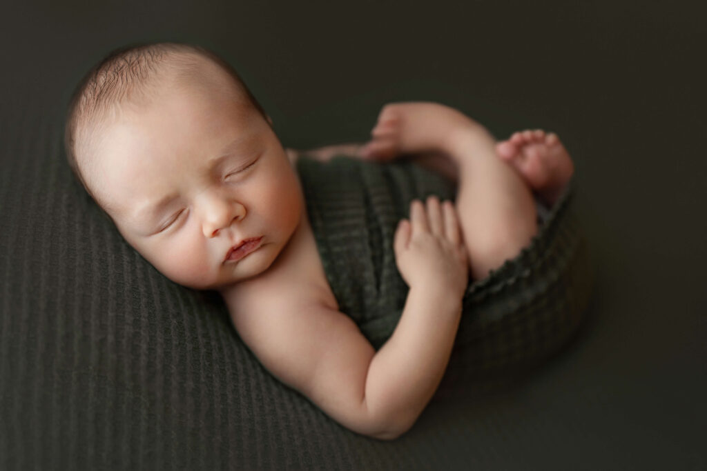 baby sleeping on his back in a ashburn va newborn photo studio