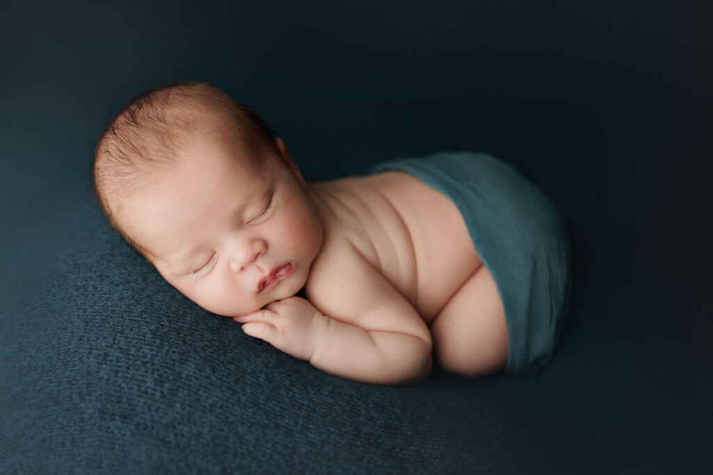 baby on a blue backdrop newborn photography dc